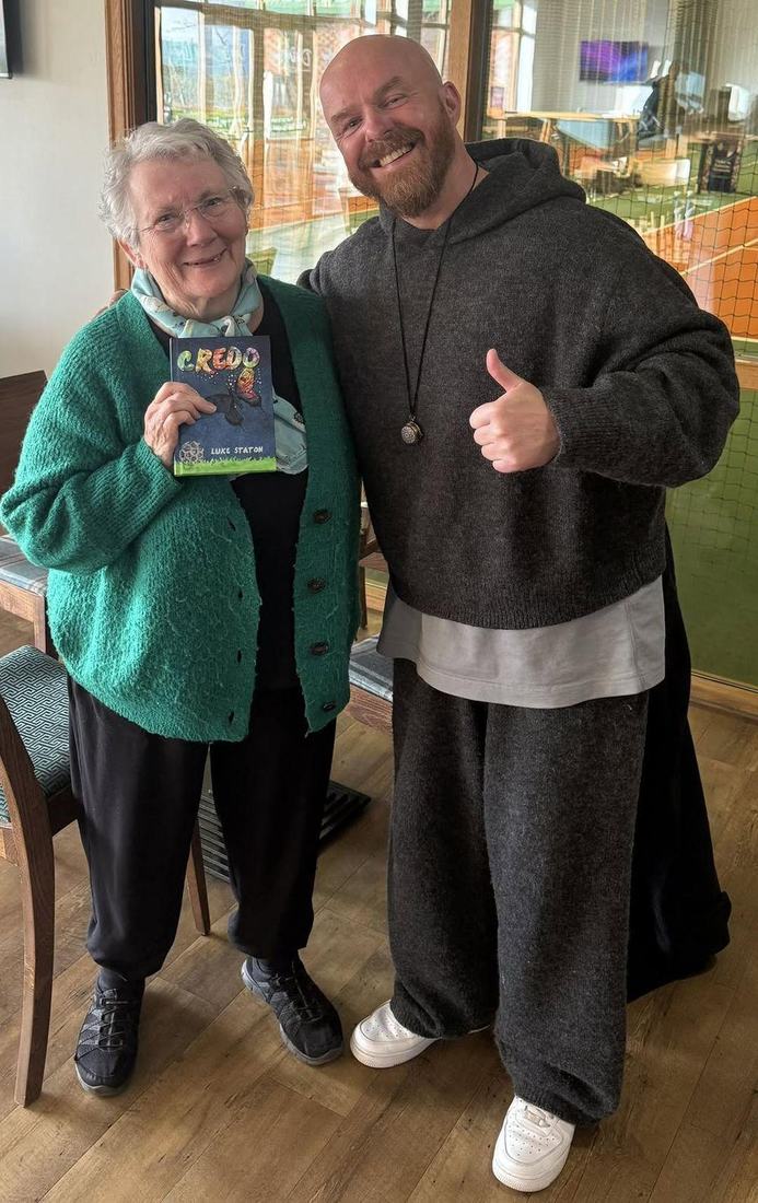 Luke Staton with Anne, 84, who holds a copy of Credo.