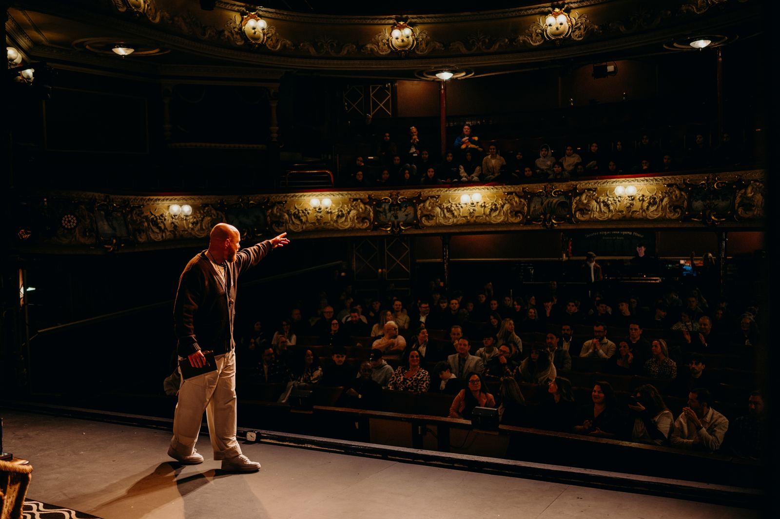 From the back of the theatre.