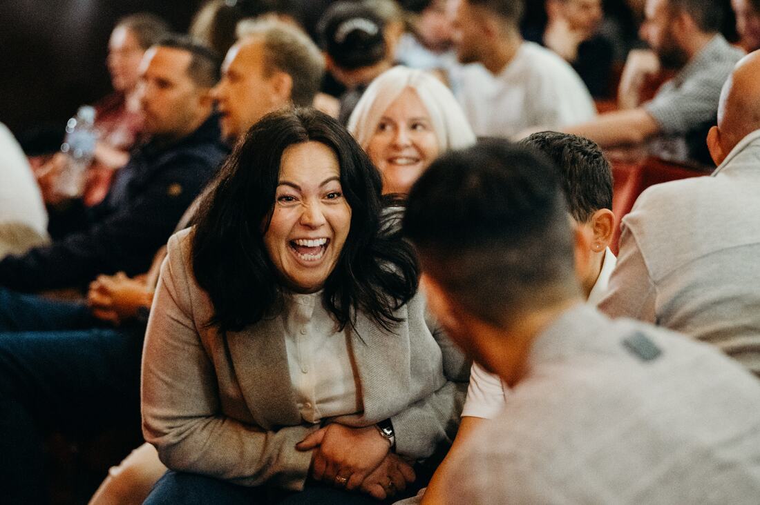 An audience member laughing at Inspire Beyond 2026.
